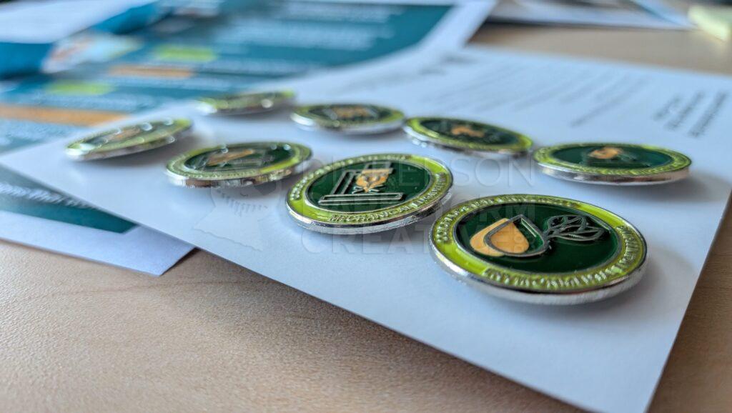 closeup photo of enamel pins on a card.